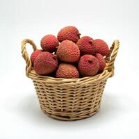 Whole fresh lychee spilling from a basket on a bright white background, emphasizing its fresh appearance and juiciness photo