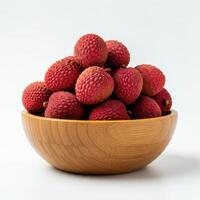 Whole fresh lychee spilling from a wooden bowl on a white background, highlighting its fresh appearance and vibrant color photo