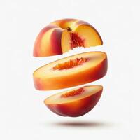 Fresh peach slices with a leaf on a white background. photo