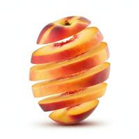 Fresh peach fruit, sliced with a leaf, resting on a white background. photo