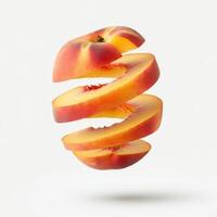 Sliced pieces of peach with a leaf, set on a clean white surface. photo
