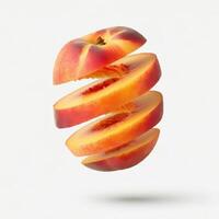 Slices of fresh peach with a leafy garnish on a white backdrop. photo