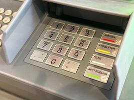 Close-up of atm keypad with buttons and numbers photo