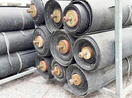 Stacked roofing felt rolls on pallet for construction usage photo