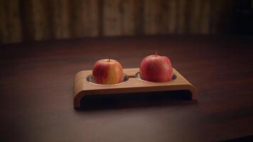 Two Fresh and Juicy Apples Artfully Displayed on a Rustic Wooden Stand for Aesthetic Appeal video