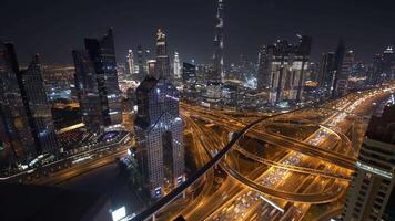 Night cityscape with illuminated skyline, complex highway interchange, and bustling metropolis view video
