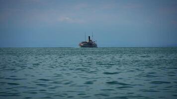 A Lonely Ship Navigating on Tranquil Waters Beneath Overcast and Cloudy Skies Above video