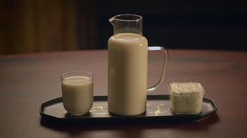 A Beautiful Display of Fresh Milk and Scrumptious Delicacies on a Rustic Wooden Table video