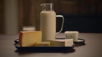 An Exquisite Dairy Selection Fresh Milk and Assorted Cheeses Displayed on a Wooden Table video