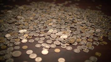 Coins on a table symbolize different aspects of economics, including abundance and wealth video