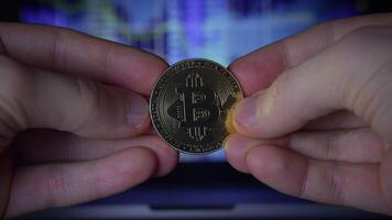 Holding a Cryptocurrency Coin Against a Background of Trading Data and Market Trends video