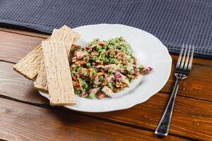 Freshgreen pea salad with scallions and purple onion on whole grain bread photo