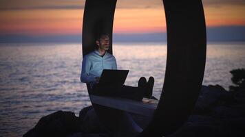Finding remote work inspiration while watching the stunning sunset by the serene sea video