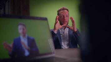 A Professional Speaker in a Studio Featuring a Green Screen Background for Presentations video