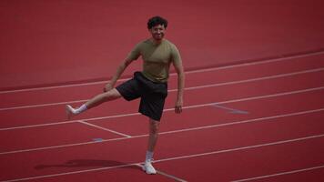 A Young Athlete Exuberantly Running on a Vibrant and Colorful Track During Practice video