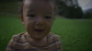 A Happy Baby is Smiling on Soft Green Grass in a Bright and Cheerful Outdoor Setting video