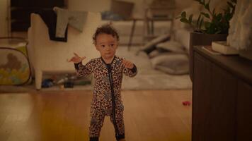 An Adorable and Cute Toddler Enjoying Playtime at Home While Dressed in Cozy Pajamas video