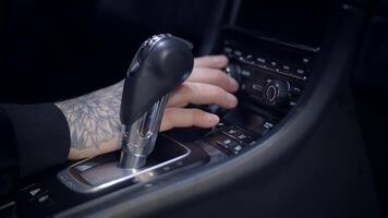 An intricate closeup view of the cars gear shift and the various dashboard controls video