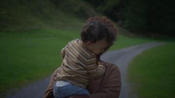 A loving mother and her joyful child cherish a serene outdoor setting, creating memories video
