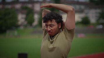 An Athlete Engaging in Stretching Exercises Before a Workout in a Beautiful Outdoor Setting video