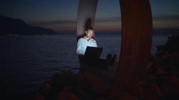 A Digital Nomad Finding Inspiration and Working By The Ocean During Dusk Hours and Sunset video