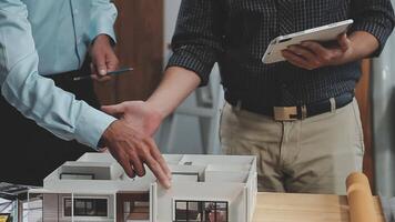 Two men shaking hands over a model of a house video