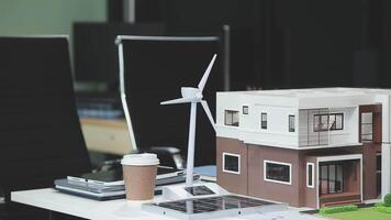 A model of a house with a wind turbine on top video
