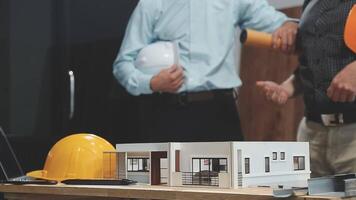 Two men are working on a model of a house video