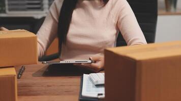 A woman is sitting at a desk with boxes video