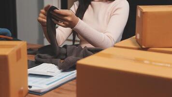 A woman is sitting at a desk with a package video