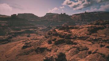 Vast arid landscape with rugged cliffs and clouds in the clear blue sky video