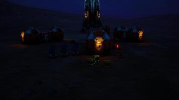 Exploration base on Mars during twilight with illuminated habitat modules video