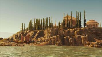 Ruins of an ancient Roman temple by the water with tall trees in daylight video