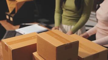 A woman is holding a box with a laptop on it video