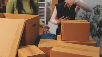 Two women are moving boxes around a table video