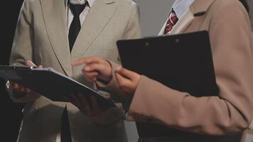 Two business people are talking about something on a clipboard video