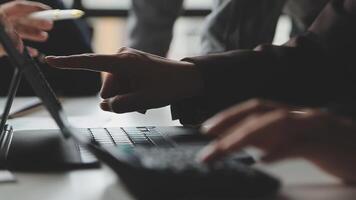 Business people using a laptop computer and pointing at it video
