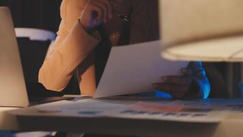 A woman is sitting at a desk with a laptop and papers video