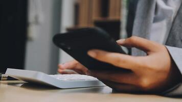 A person using a cell phone and a calculator video