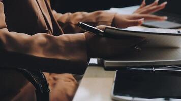 A person is writing in a notebook while sitting at a desk video