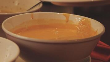 A bowl of soup with a spoon in it video