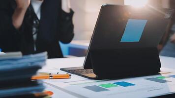 A laptop is sitting on a desk with a person standing behind it video