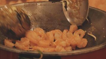A pan with shrimp and onions cooking on it video