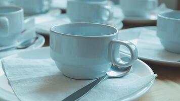 A table with many white cups and saucers video