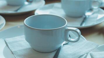 A table with white cups and saucers on it video