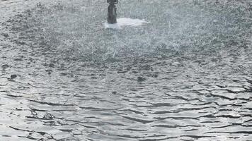 A man is standing in the middle of a fountain video