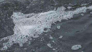 A close up of a wave with bubbles coming out of it video