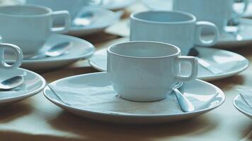 A table with many white cups and saucers video