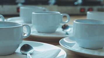 Several white coffee cups and saucers on a table video