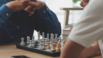 Two people playing chess at a table video